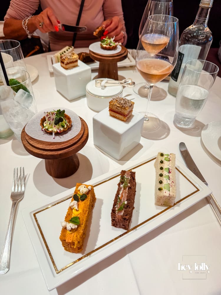 Savoury afternoon tea plates on individual stands and sandwiches at The Georgian Harrods